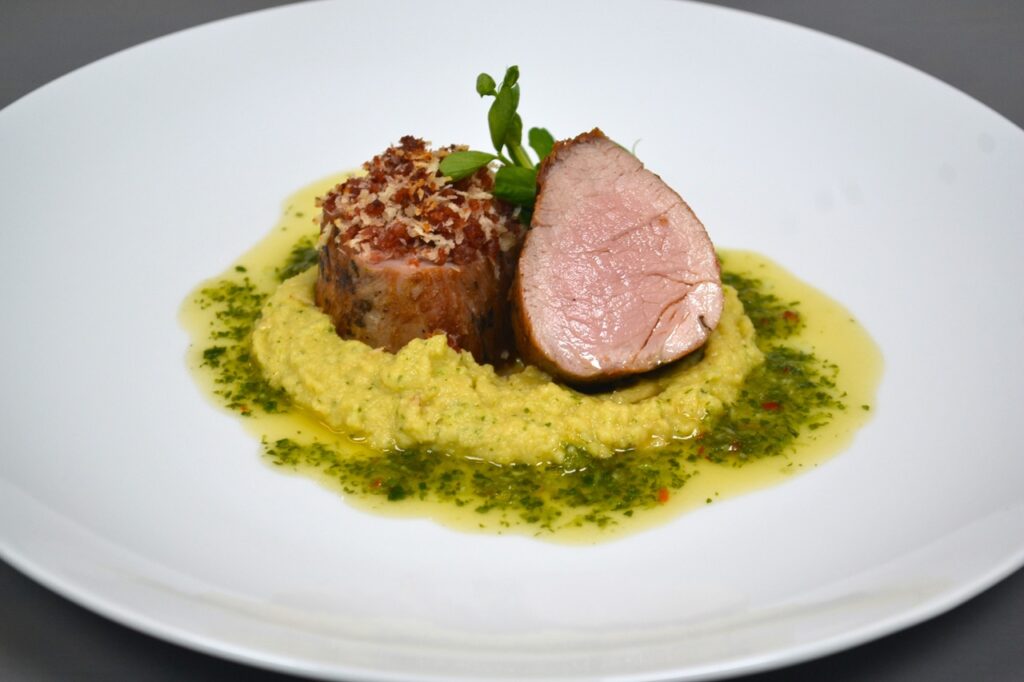 Vie d'été Crispy bacon crusted roast pork filet, cold hummus, verde sauce